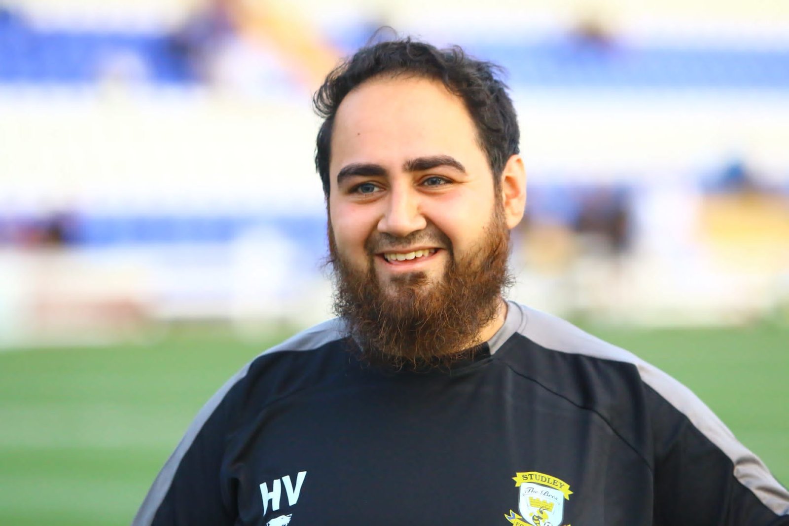 Matchday portrait of Huzefa Vorajee in coaching kit at a non-league ground